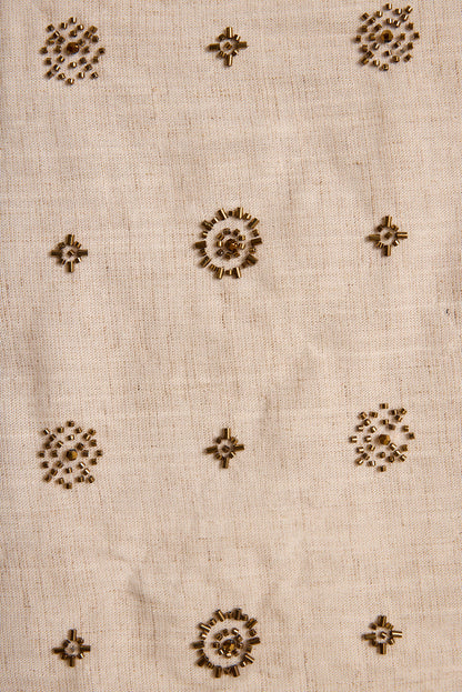 Gold beaded flower motifs scattered across the natural linen Camila tank fabric.
